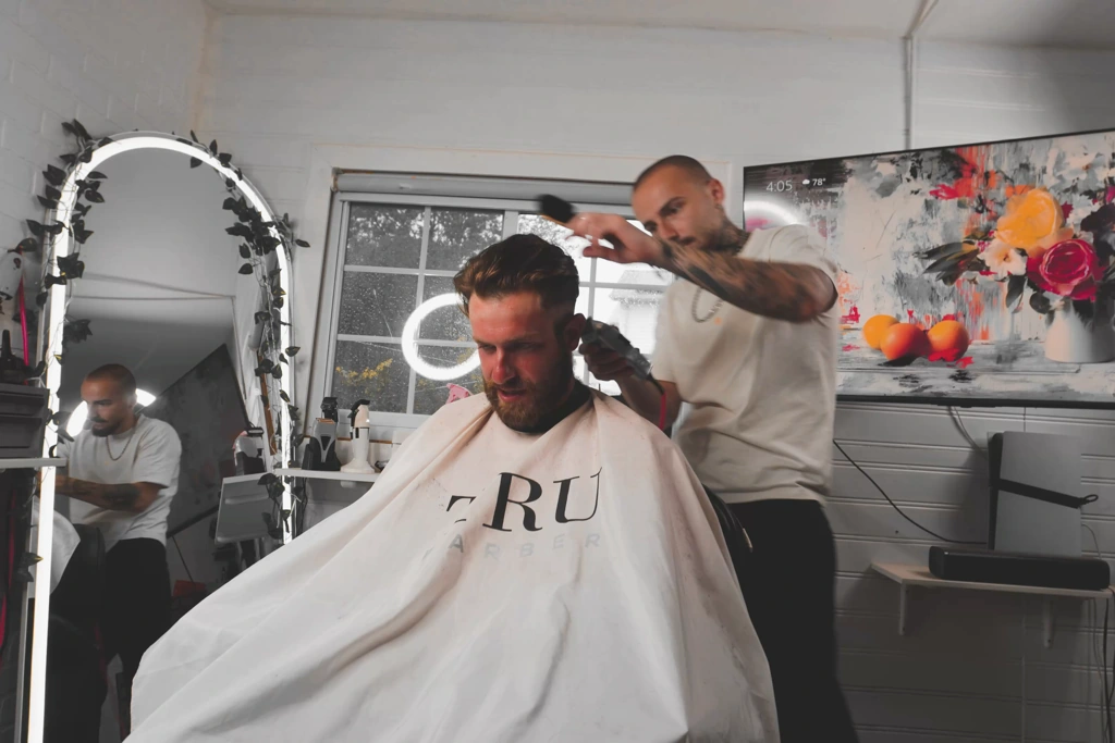 Elvis Krasniqi cutting a client's hair at MisterECuts, Staten Island