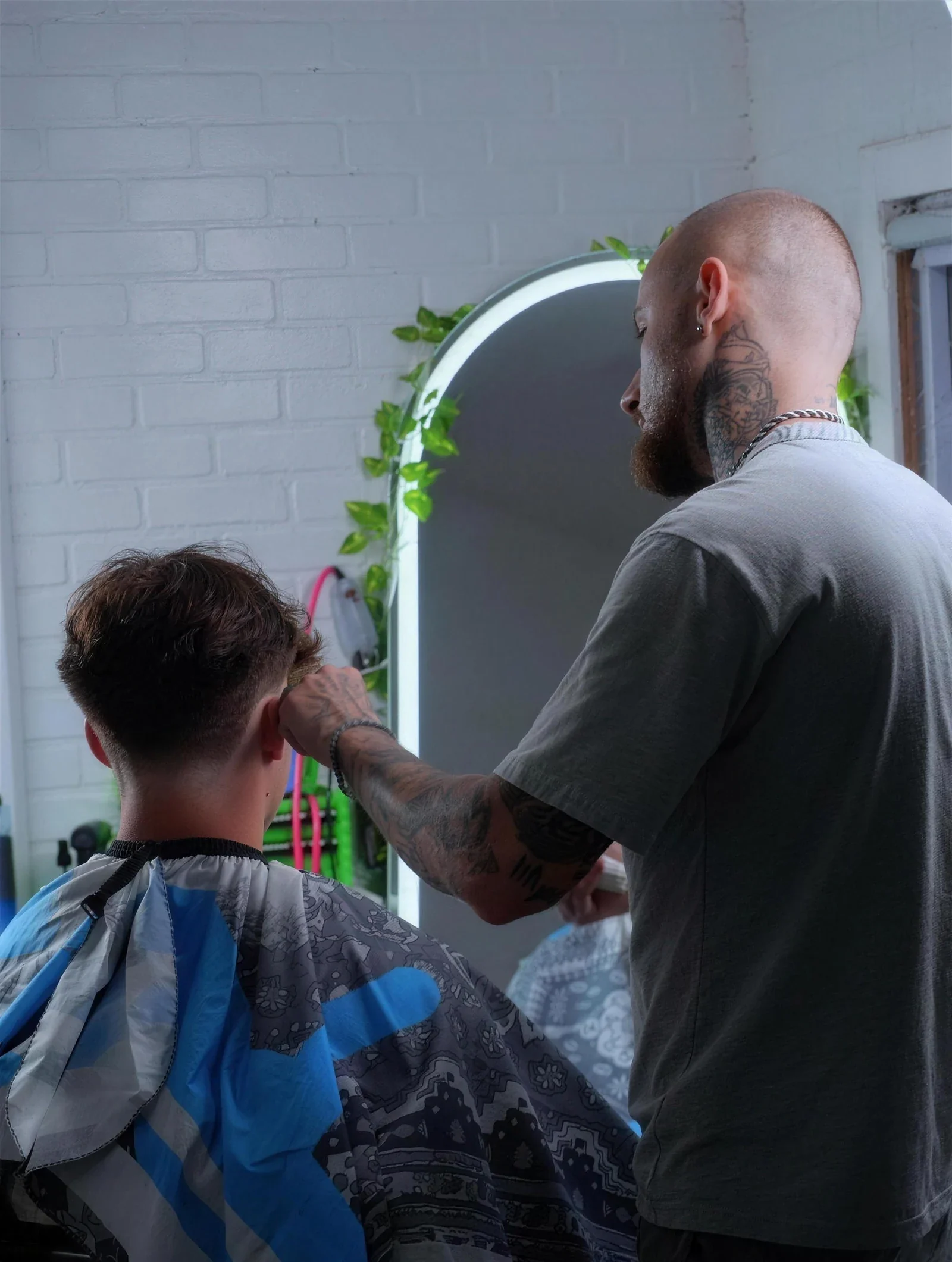 Elvis Krasniqi cutting a client's hair at MisterECuts