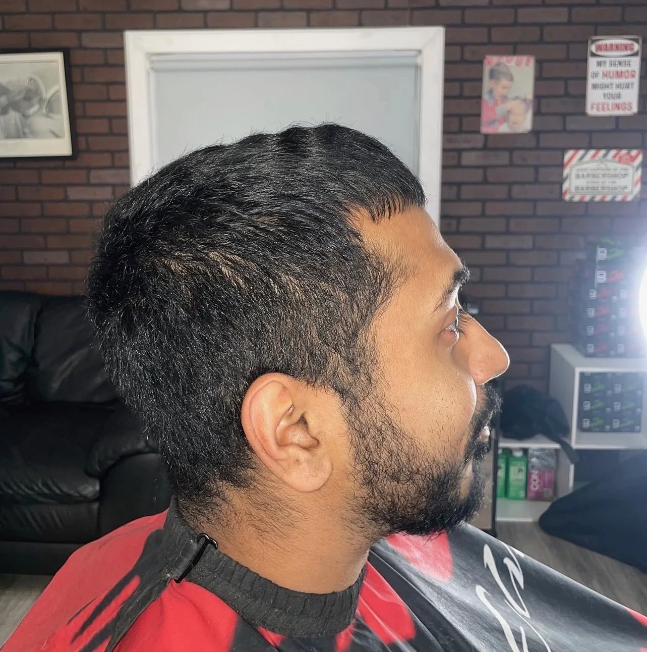 Client before the cut, hair grown out over the ears and down the neck
