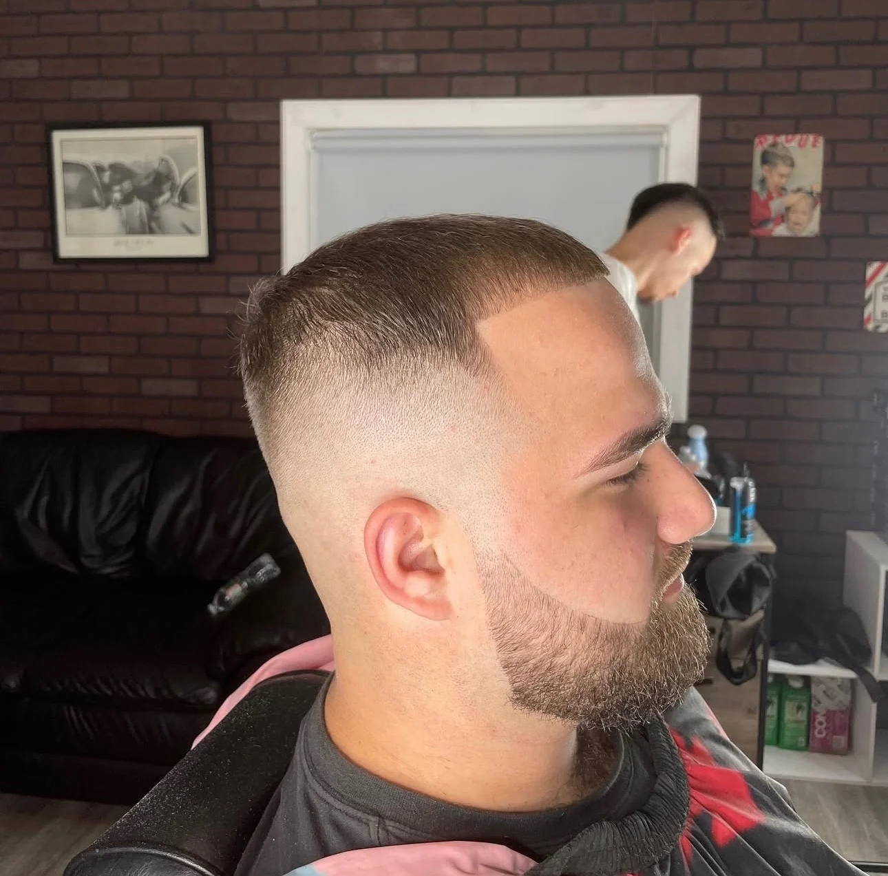 The same client after a skin fade with the beard shaped and lined into the cut